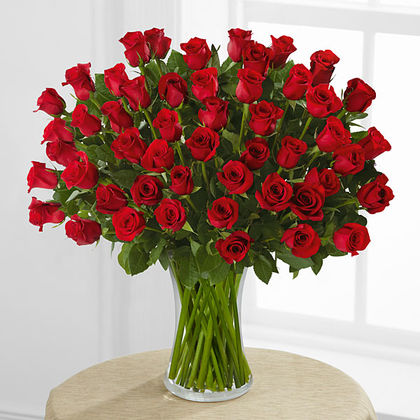 Deluxe-Fifty Red Roses Arranged in Clear vase